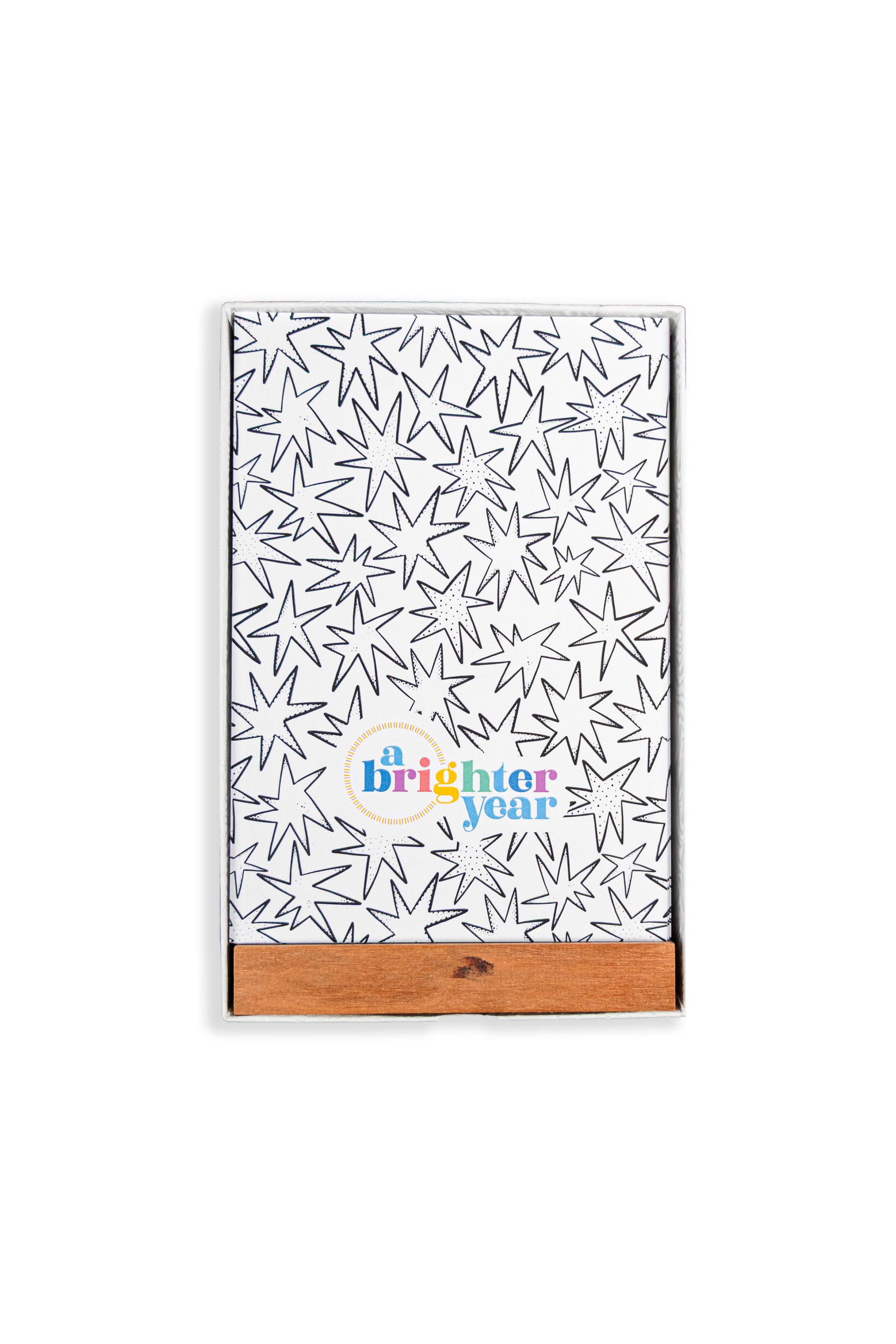 A color your own tarot deck in a box with a black starburst pattern and a colorful 'a Brighter year' logo near the bottom. It has a natural wood slide cover and is photographed on a clean white background.